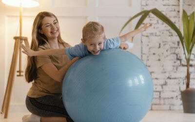 full shot woman holding kid gym ball